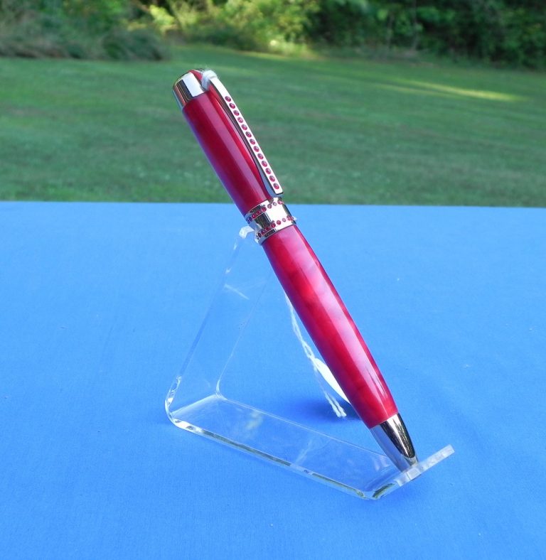 This pen has bling, small red stones on the clip and band, as well as a radiant red composite body.