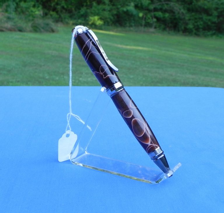 Large composite pen with brown and white swirls.