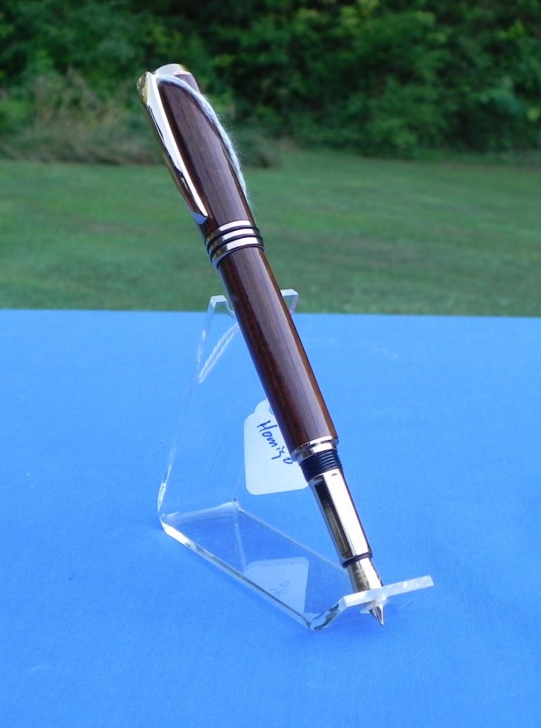 Fountain pen made with pheasant wood, uses refillable cartridges.
