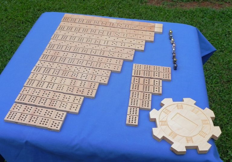 A full set of 12/12 dominoes with tokens and center hub